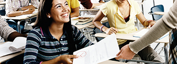 Student giving CELT-S teacher her English homework